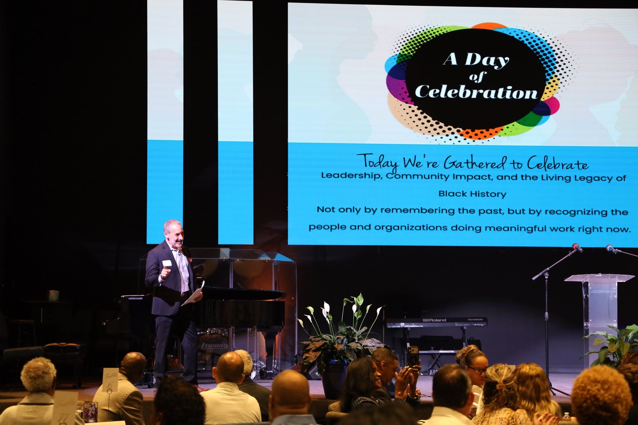 Jay Scherr speaking at a community event before a seated audience